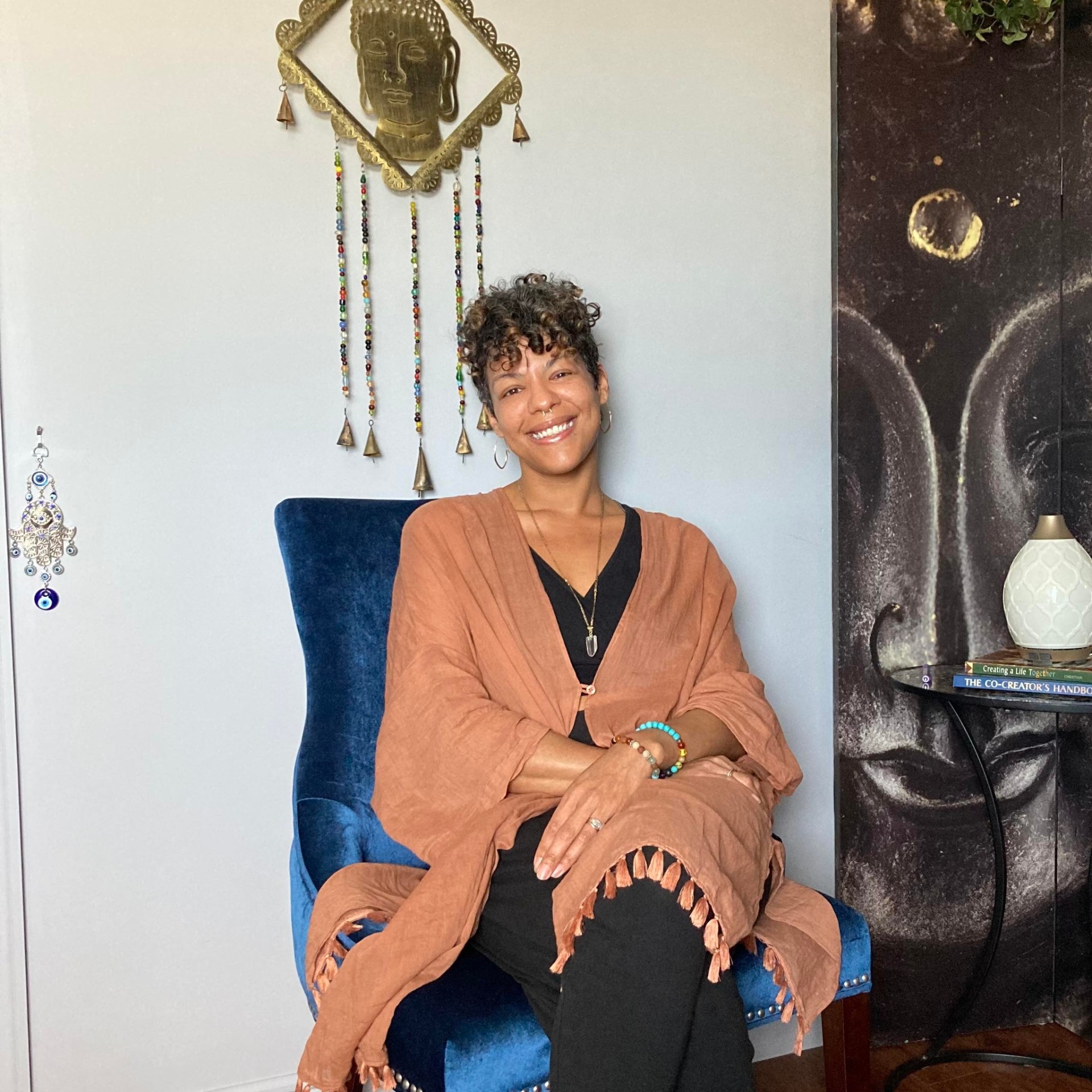 Hev Michel, founder and coach, seated in her studio